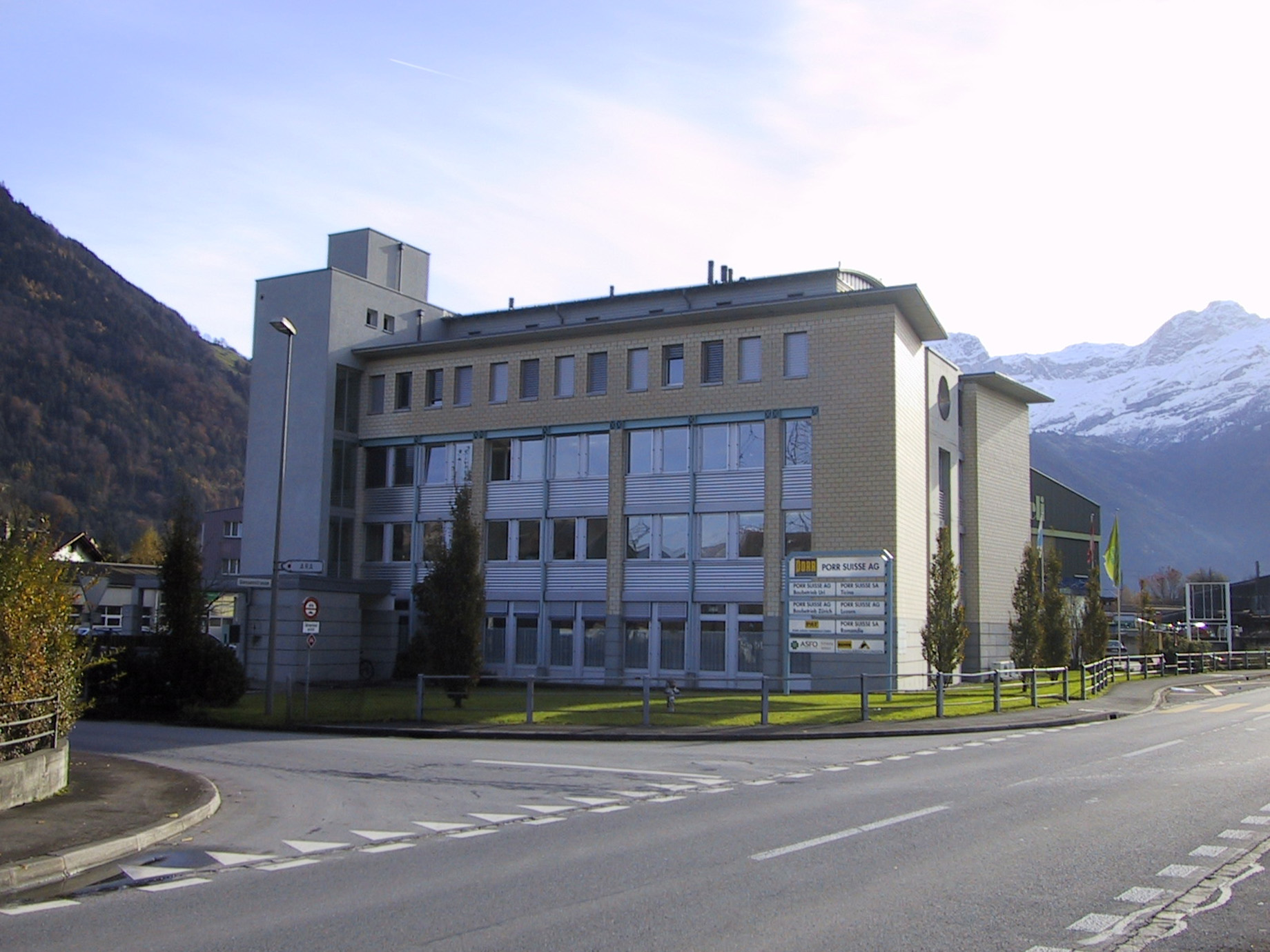 Photo: modern office building in front of snow-capped mountain landscape